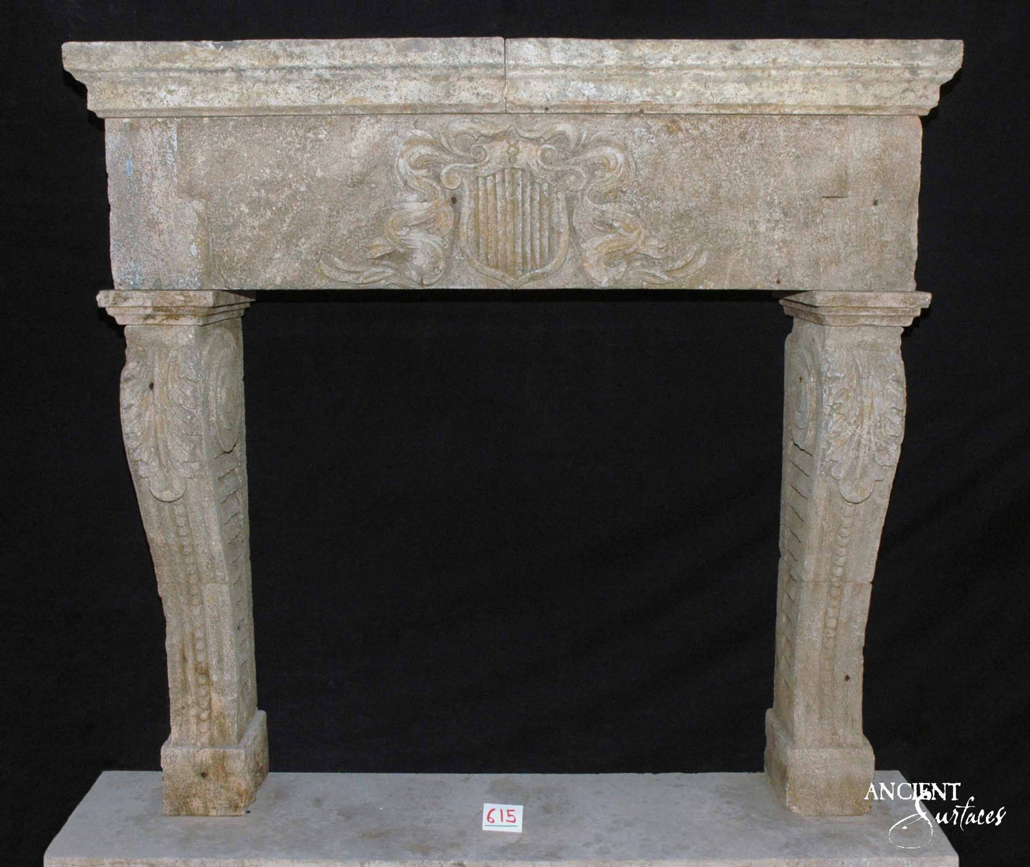 Heirloom Prestige: Reclaimed Limestone Mantle with Emblematic Carvings
